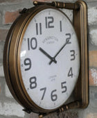 Vintage-style wall clock with brass frame on a brick wall.