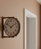 Vintage-style wall clock on a beige wall with a door frame in the background