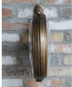 Brass door handle on a brick wall