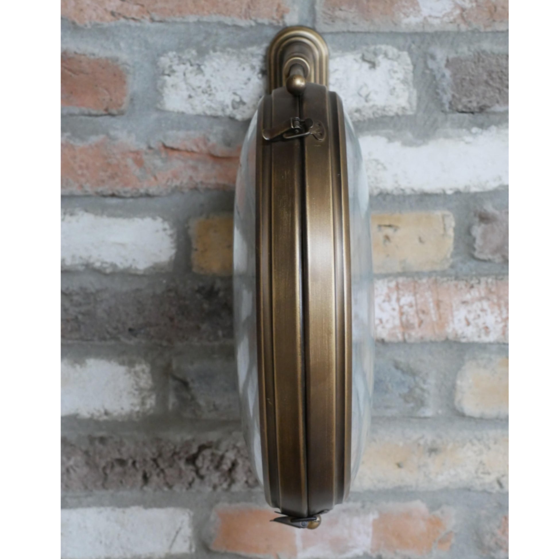Brass door handle on a brick wall