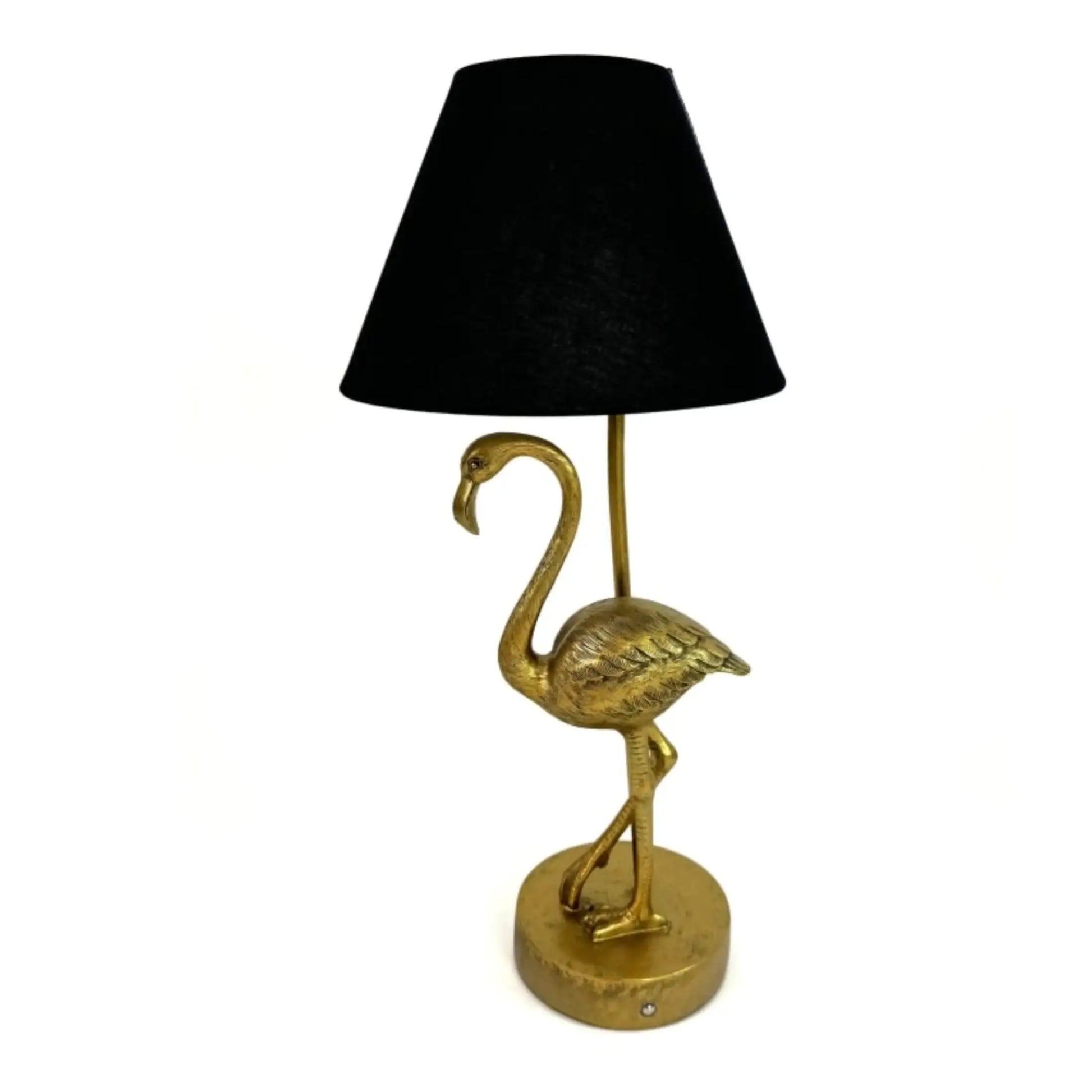 Gold flamingo-shaped table lamp with a black lampshade on a white background