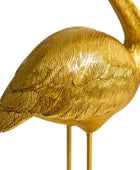 Gold bird sculpture on a white background