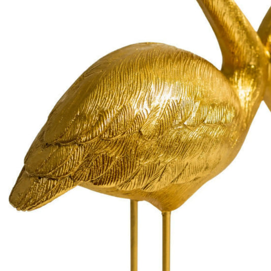 Gold bird sculpture on a white background
