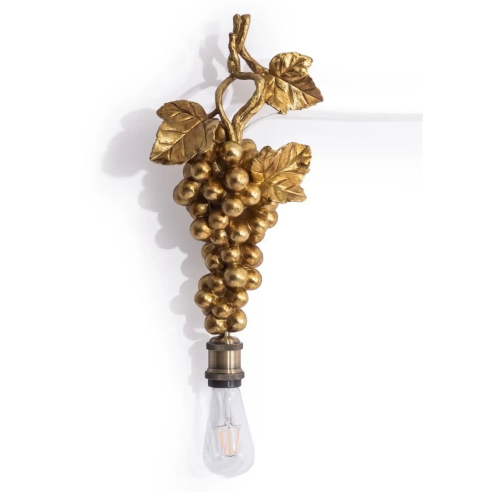 Decorative wall light fixture with gold grapes and leaves on a white background