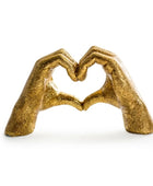 Bronze sculpture of two hands forming a heart shape on a white background