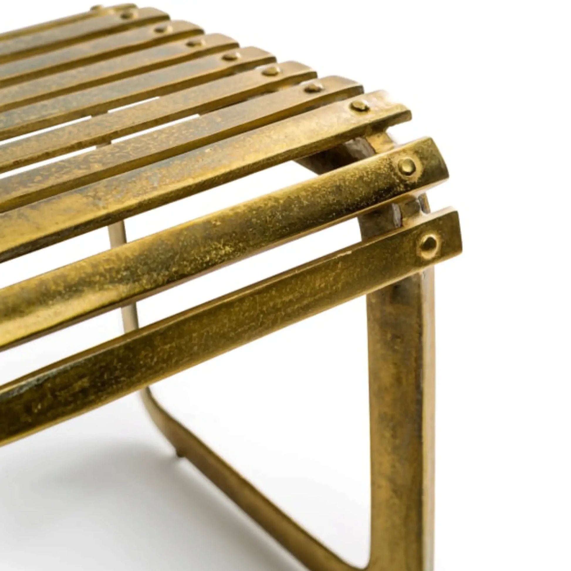 Close-up of a brass metal stool on a white background
