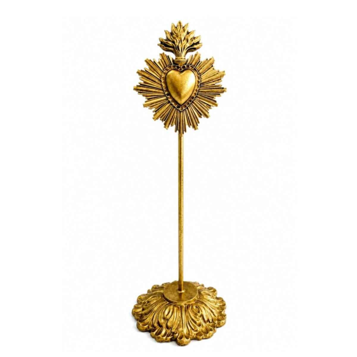 A gold Sacred Heart of Jesus tabletop candle holder featuring an ornate base, a slender stem, and a decorative top with a radiant halo and central heart, shown on a plain white background.