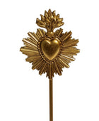 A gold-colored Sacred Heart of Jesus metal pin on a white background.