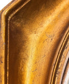 Close-up of a textured gold mirror frame