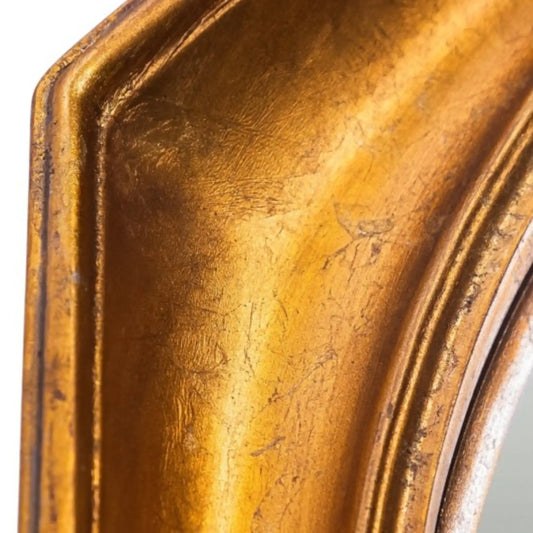 Close-up of a textured gold mirror frame