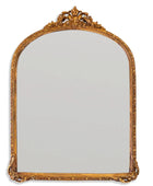 Decorative gold-framed mirror on a white background