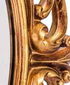 Close-up of a gold ornate frame corner on a white background