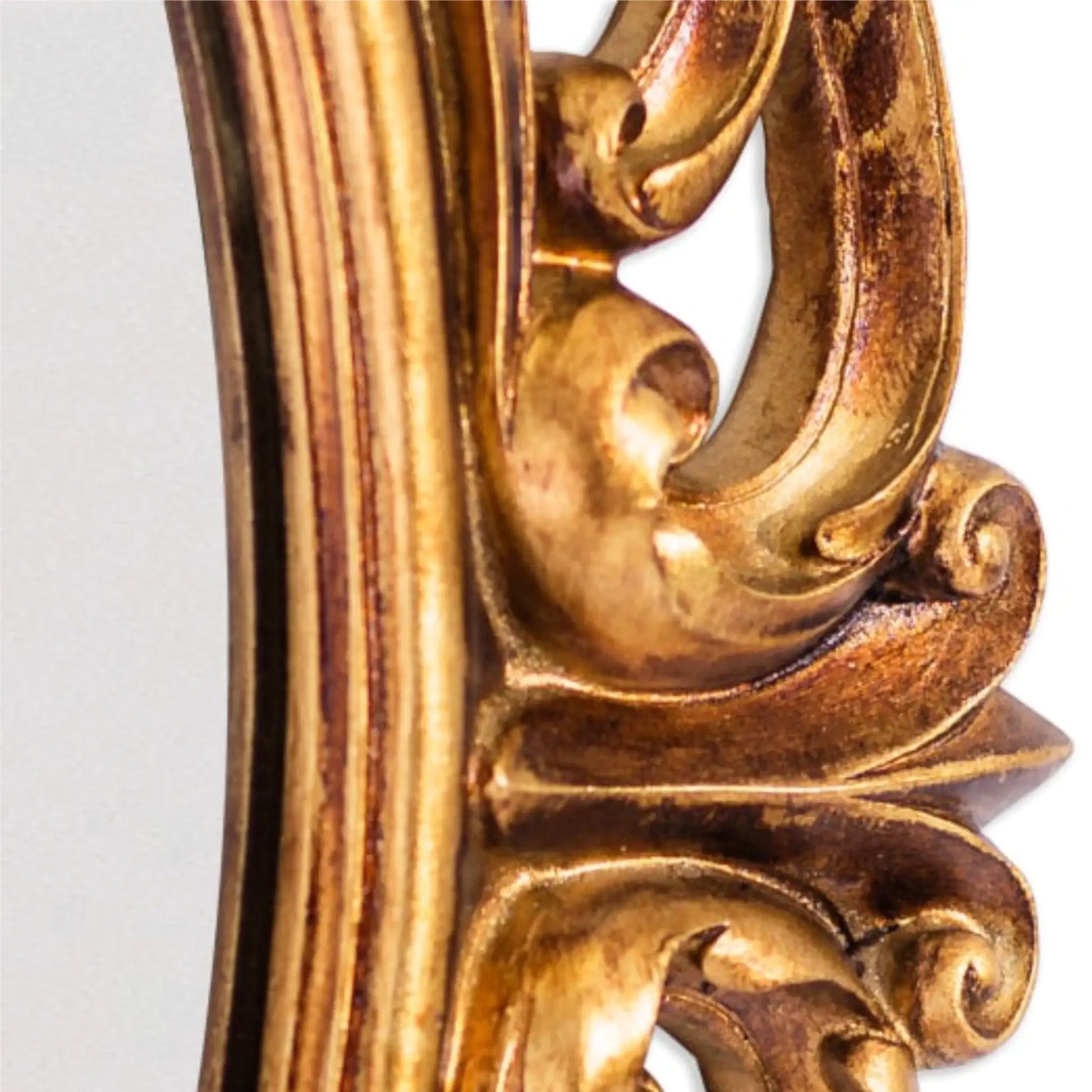 Close-up of a gold ornate frame corner on a white background