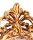 Decorative gold emblem with intricate patterns on a white background