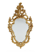 Decorative gold mirror with intricate designs on a white background