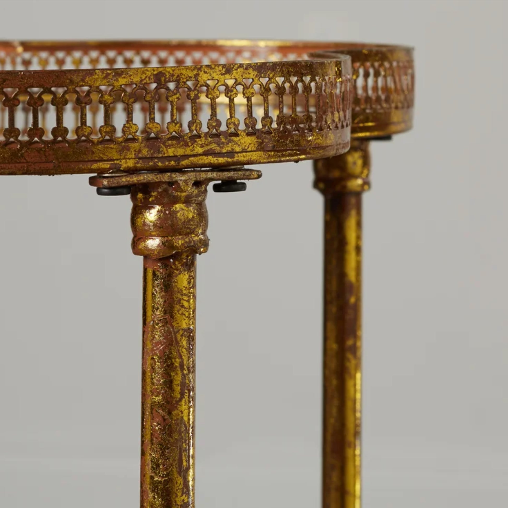 Decorative gold table with intricate design on a gray background