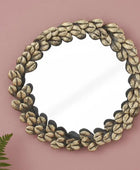 Decorative mirror with leaf-like frame on a white background