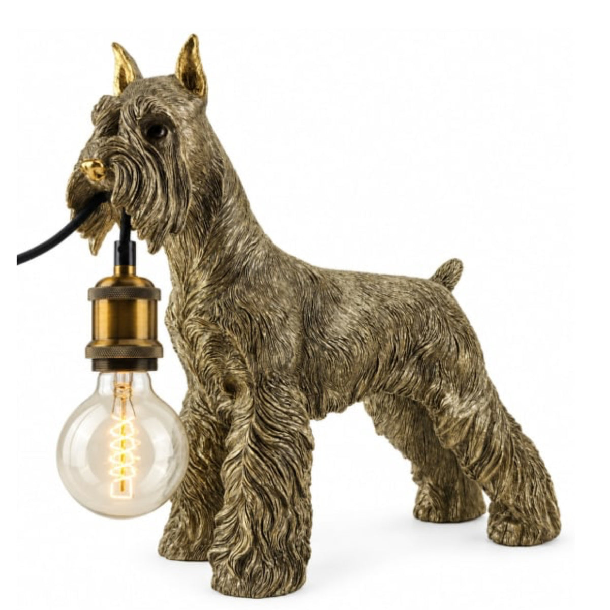 A decorative table lamp shaped like a Scottish Terrier dog, holding a clear light bulb in its mouth. The dog figure has a textured brown and gray coat with gold-toned ears and muzzle details, and the bulb socket has a brass-colored metal cap.