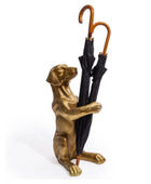 Bronze dog-shaped umbrella stand holding an umbrella on a white background
