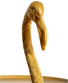 Gold flamingo-shaped object on a white background