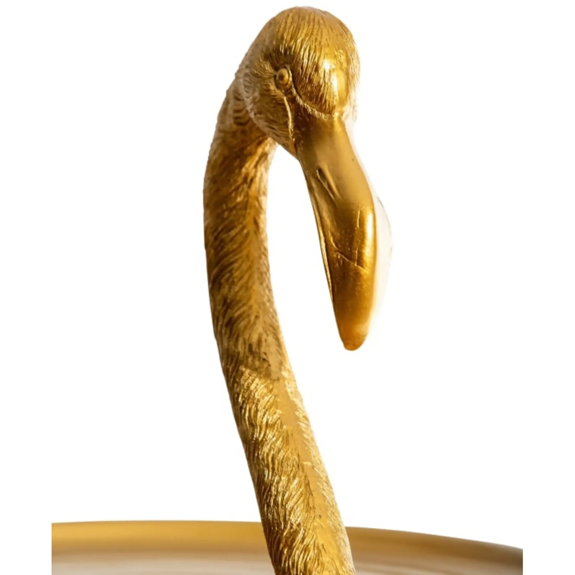 Gold flamingo-shaped object on a white background
