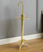 Brass umbrella stand on a white background