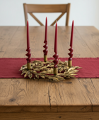 Decorative candle holder with five candles on a white background