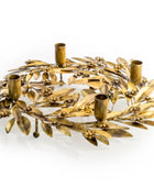 Decorative gold wreath with candle holders on a white background