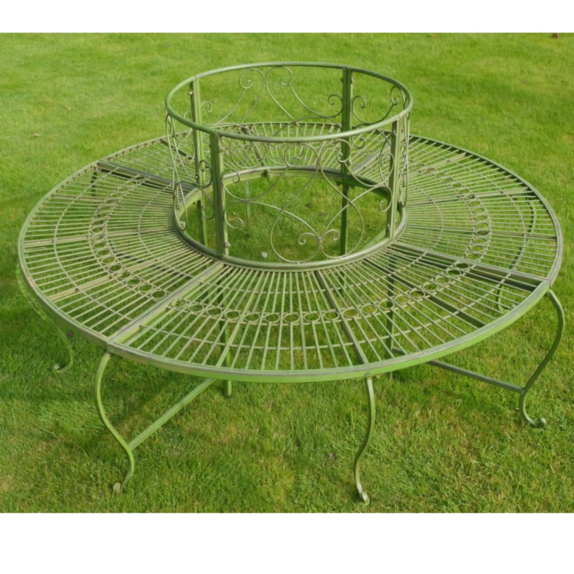 Decorative metal garden table on a grassy background