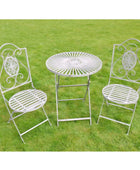 White metal garden table and chairs on a grassy background