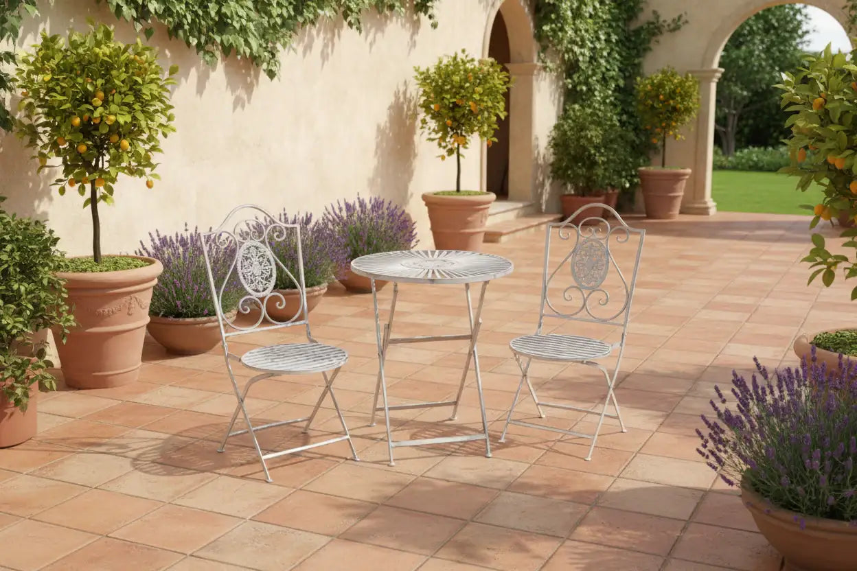 Outdoor patio set with table and chairs on a tiled patio surrounded by plants and lavender.