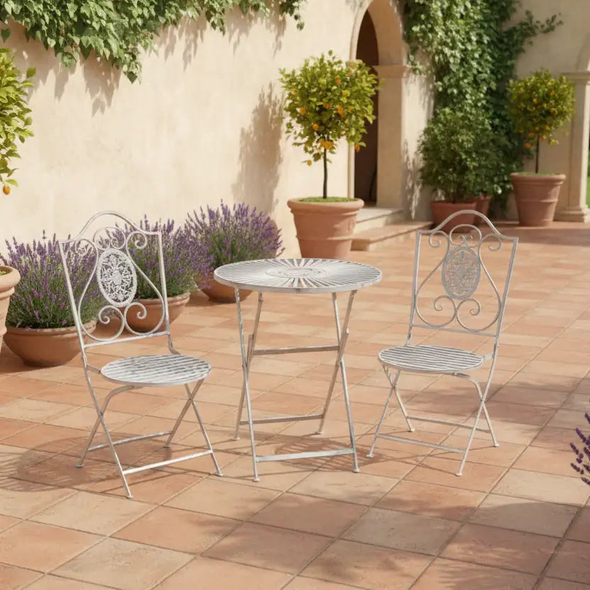 Outdoor patio set with metal table and chairs on a tiled patio.