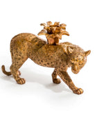 Bronze leopard figurine with a flower-shaped object on its back against a white background