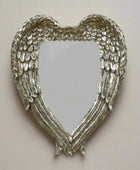 Heart-shaped mirror with angel wings on a white background