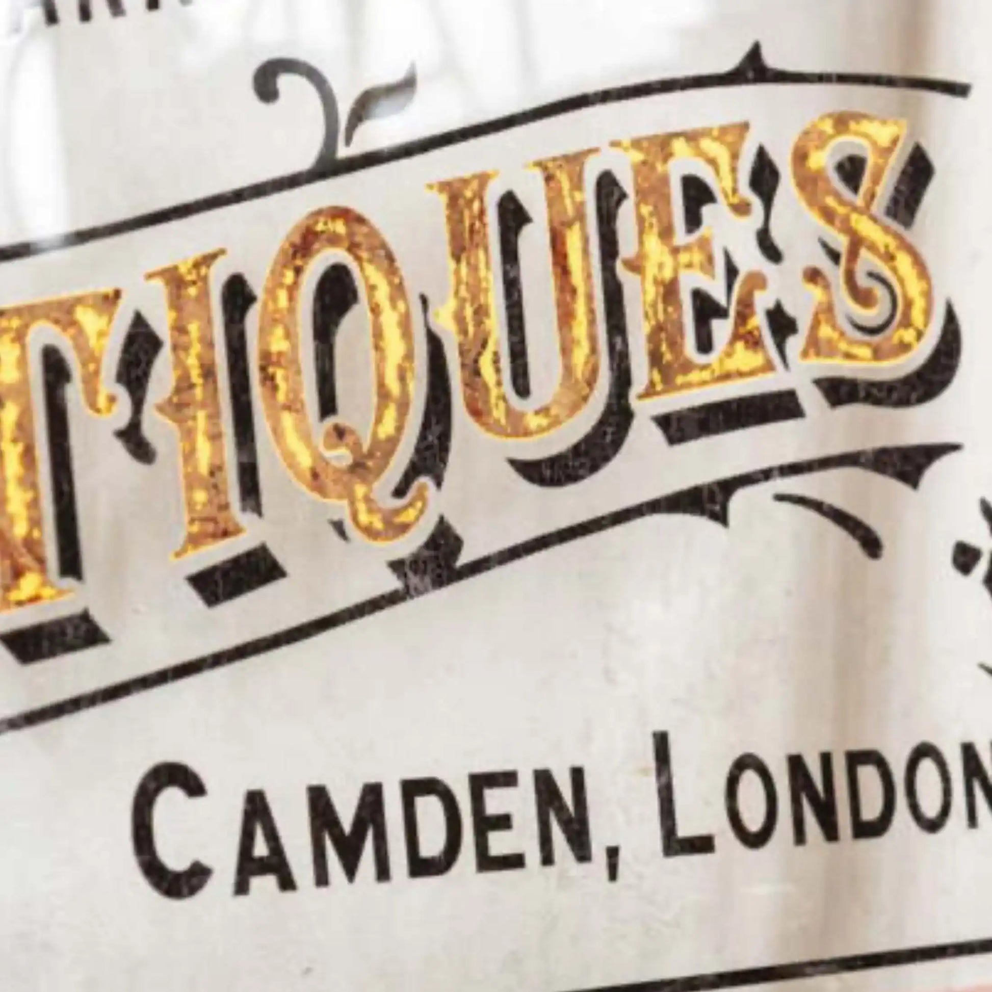 Vintage-style sign with 'Antiques' and 'Camden, London' text on a white background