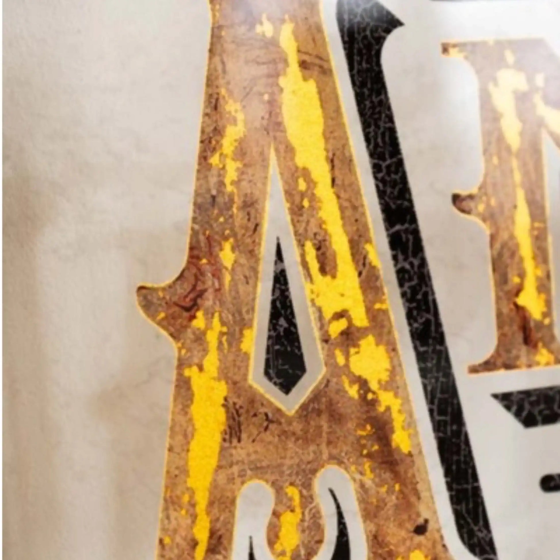 Close-up of a distressed metal sign with 'A' and 'N' letters.
