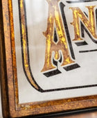 Decorative sign with 'AN' in a decorative frame on a white background