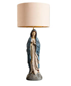 Statue of a religious figure with a beige lampshade on a white background