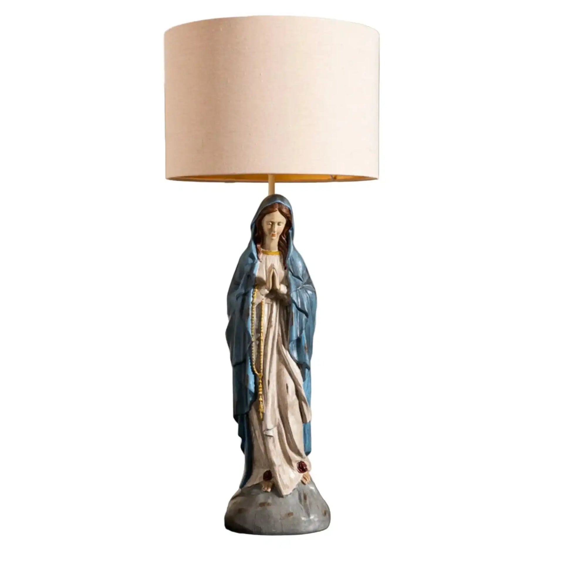 Statue of a religious figure with a beige lampshade on a white background