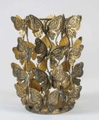 Decorative candle holder with butterfly designs on a white background