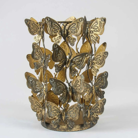 Decorative candle holder with butterfly designs on a white background