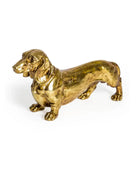 Gold-colored dachshund figurine on a white background
