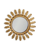 Decorative gold sunburst mirror on a white background