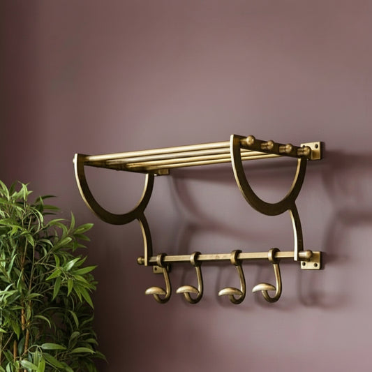 Brass towel rack with hooks on a purple wall
