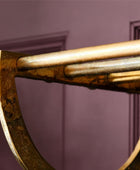 Close-up of a bronze axe head against a gray background