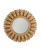 Decorative gold mirror with sunburst design on a white background