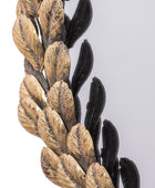Decorative leaf design in gold and black on a white background