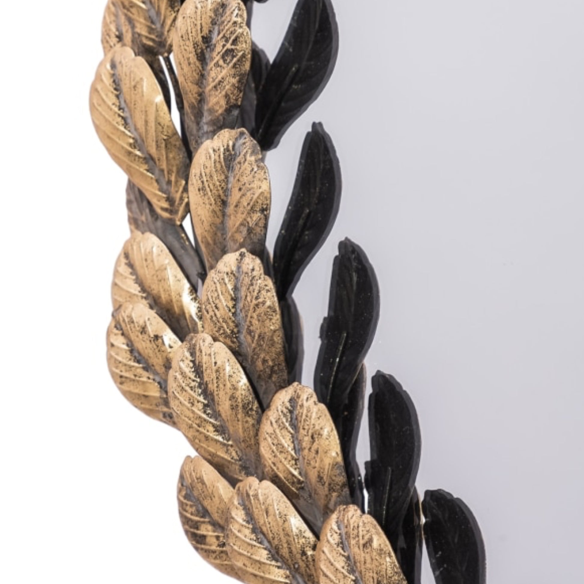 Decorative leaf design in gold and black on a white background