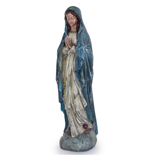 Statue of a religious figure in a blue robe on a white background