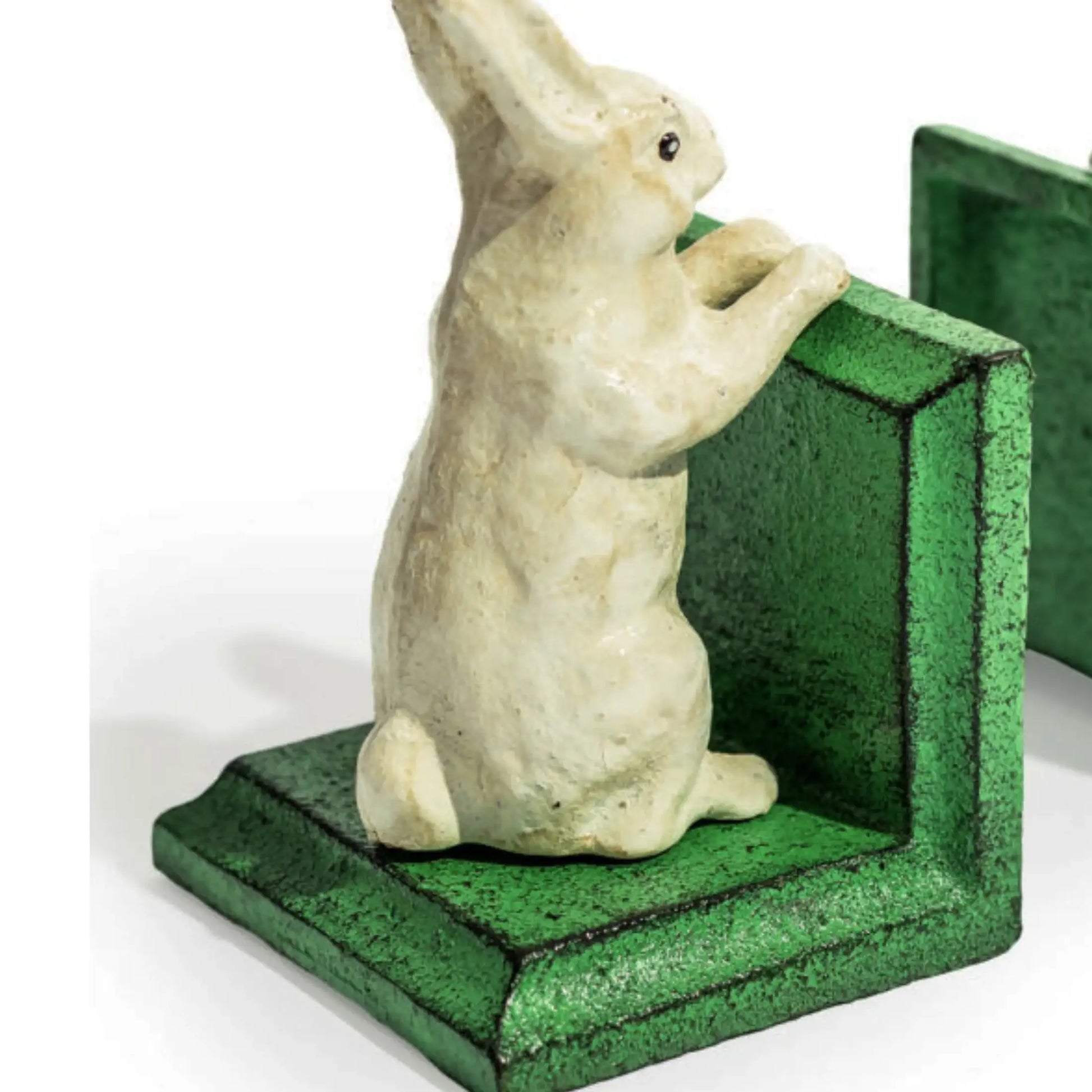 Statue of a rabbit on a green base with a white background